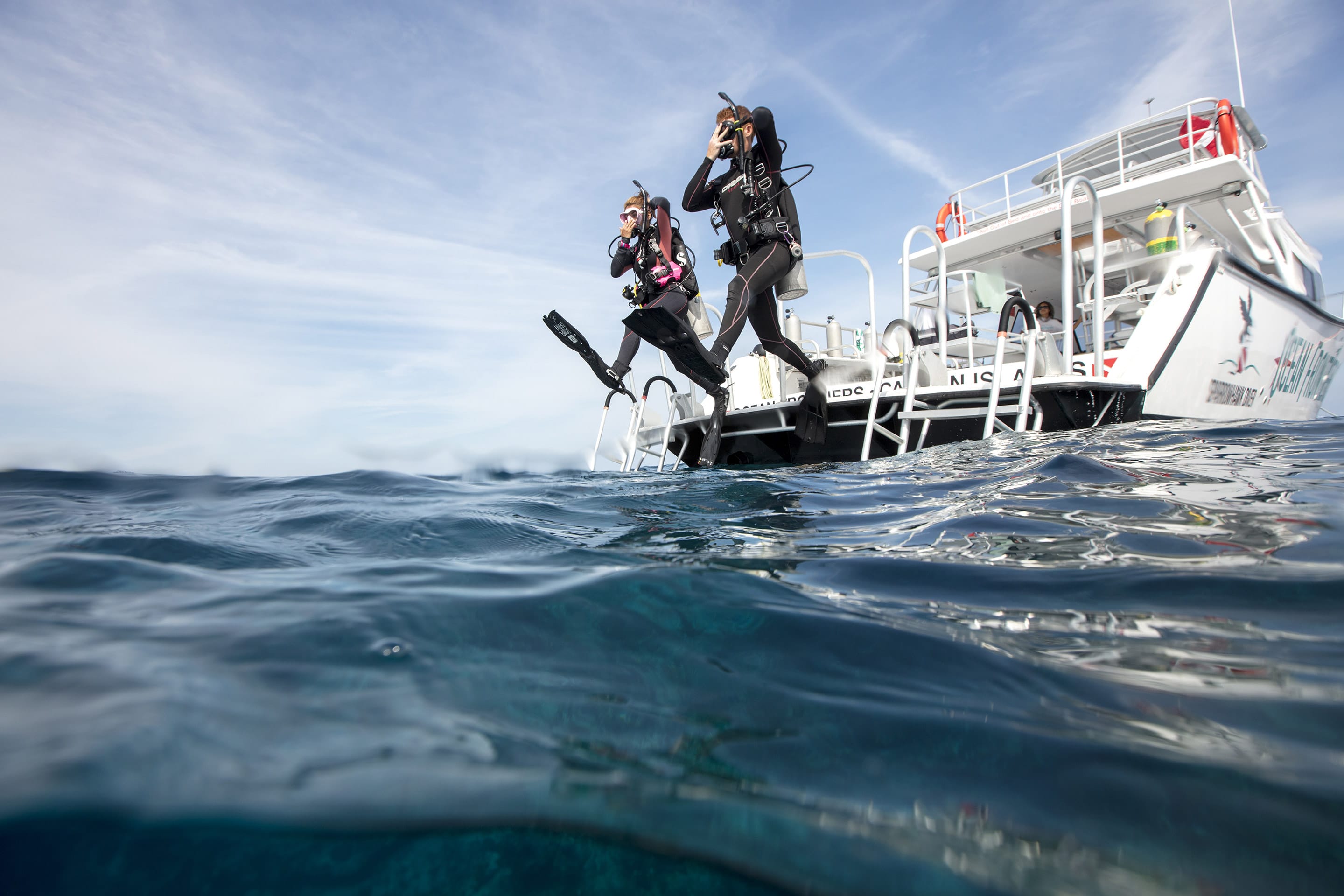 Scuba students entering the water from a Key Largo training boat