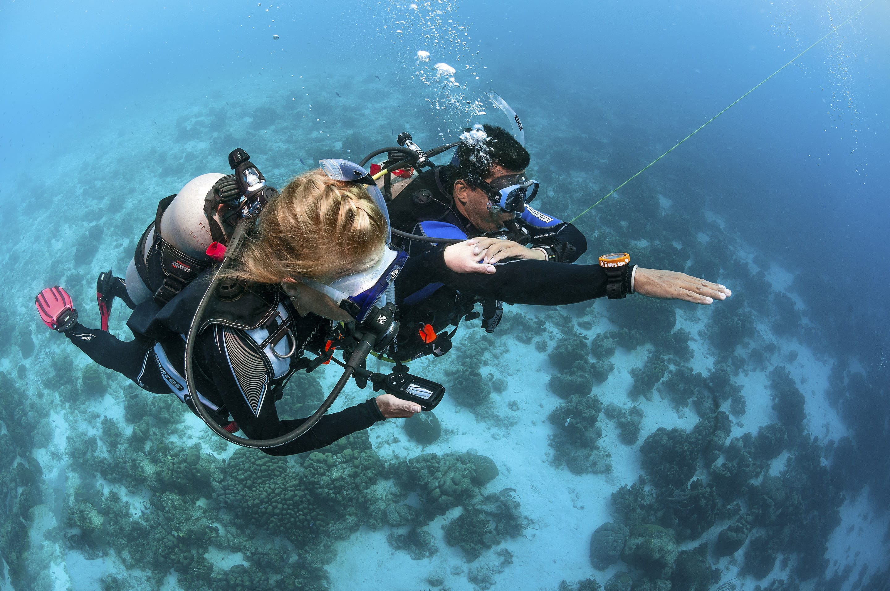 Open Water student practicing with close instructor support over a calm Key Largo reef